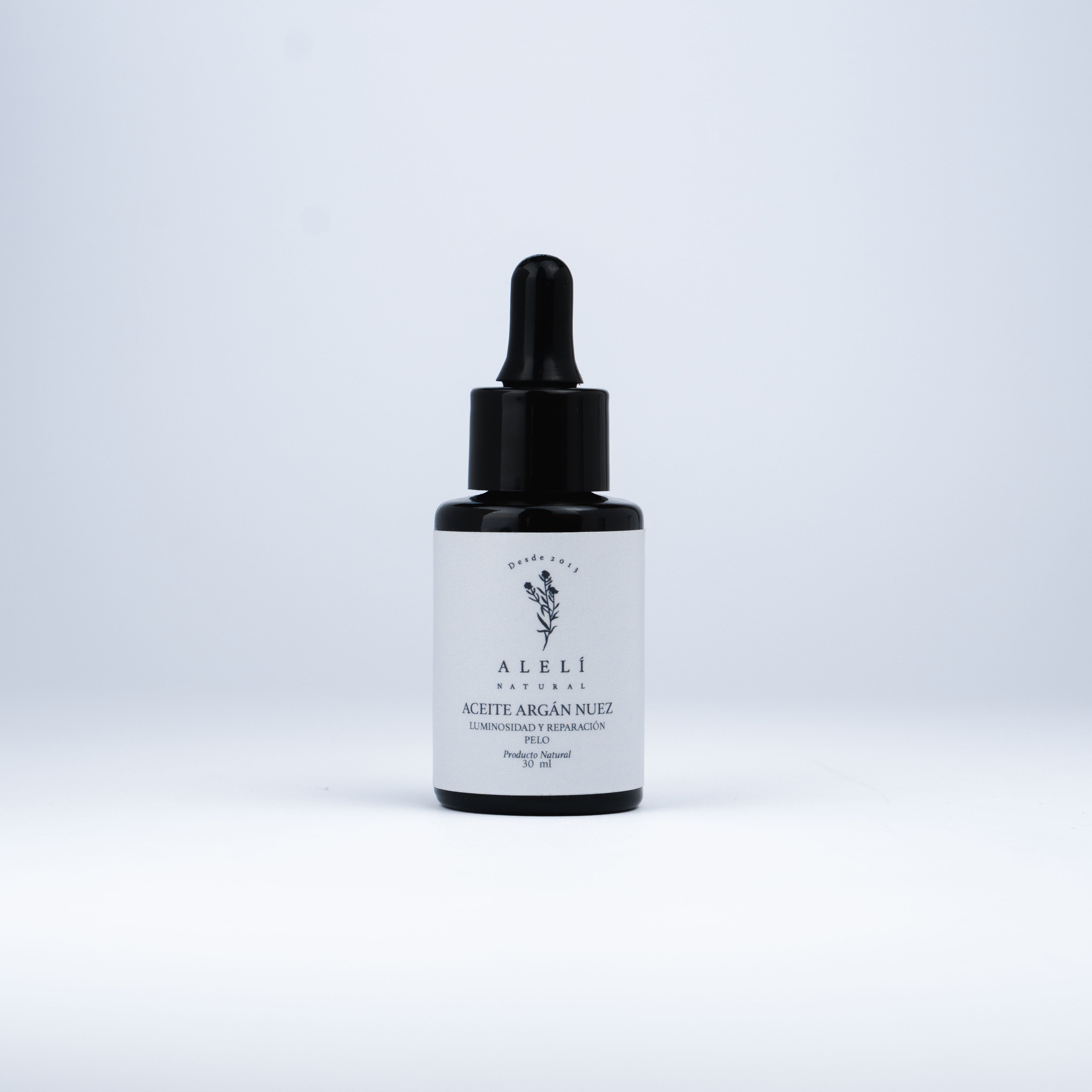 Vista frontal del Aceite Capilar Restaurador de Argán Nuez Alelí Natural de 30 ml con envase gotero ámbar.