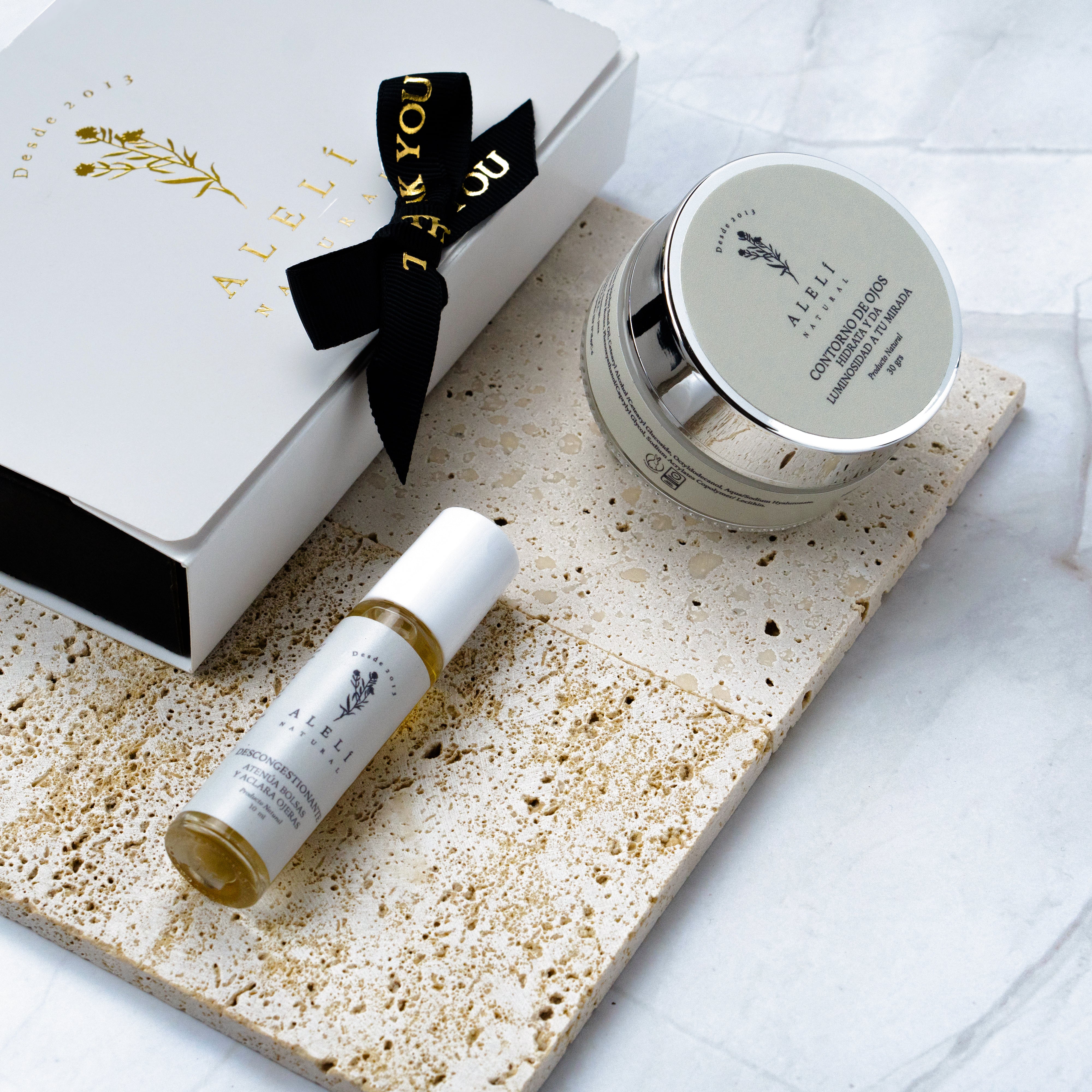 Vista frontal del Pack Mirada Iluminada Alelí Natural, que incluye Sérum Desinflamatorio y Contorno de Ojos Hidratante.