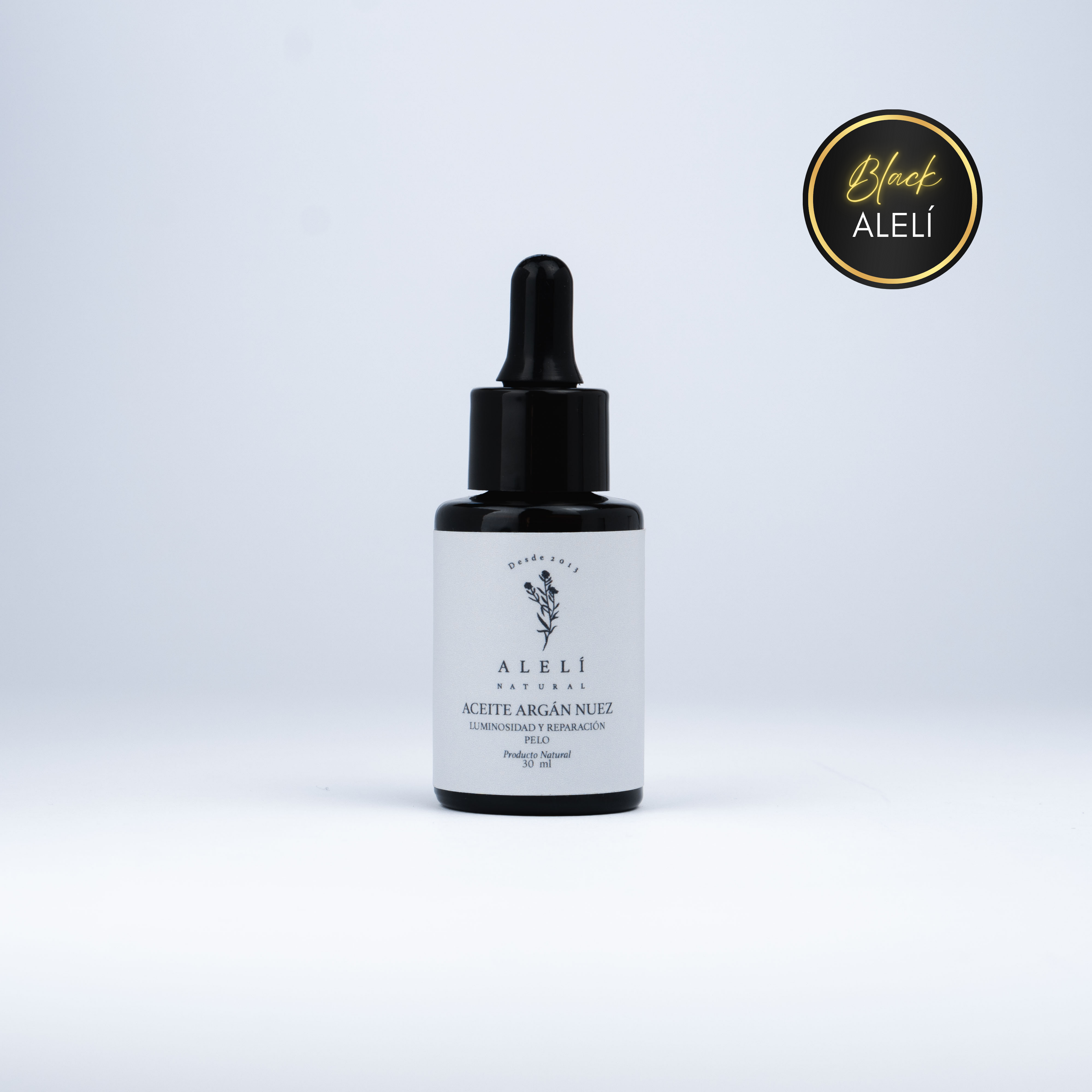 Vista frontal del Aceite Capilar Restaurador de Argán Nuez Alelí Natural de 30 ml con envase gotero ámbar. Black Alelí 35% Off.