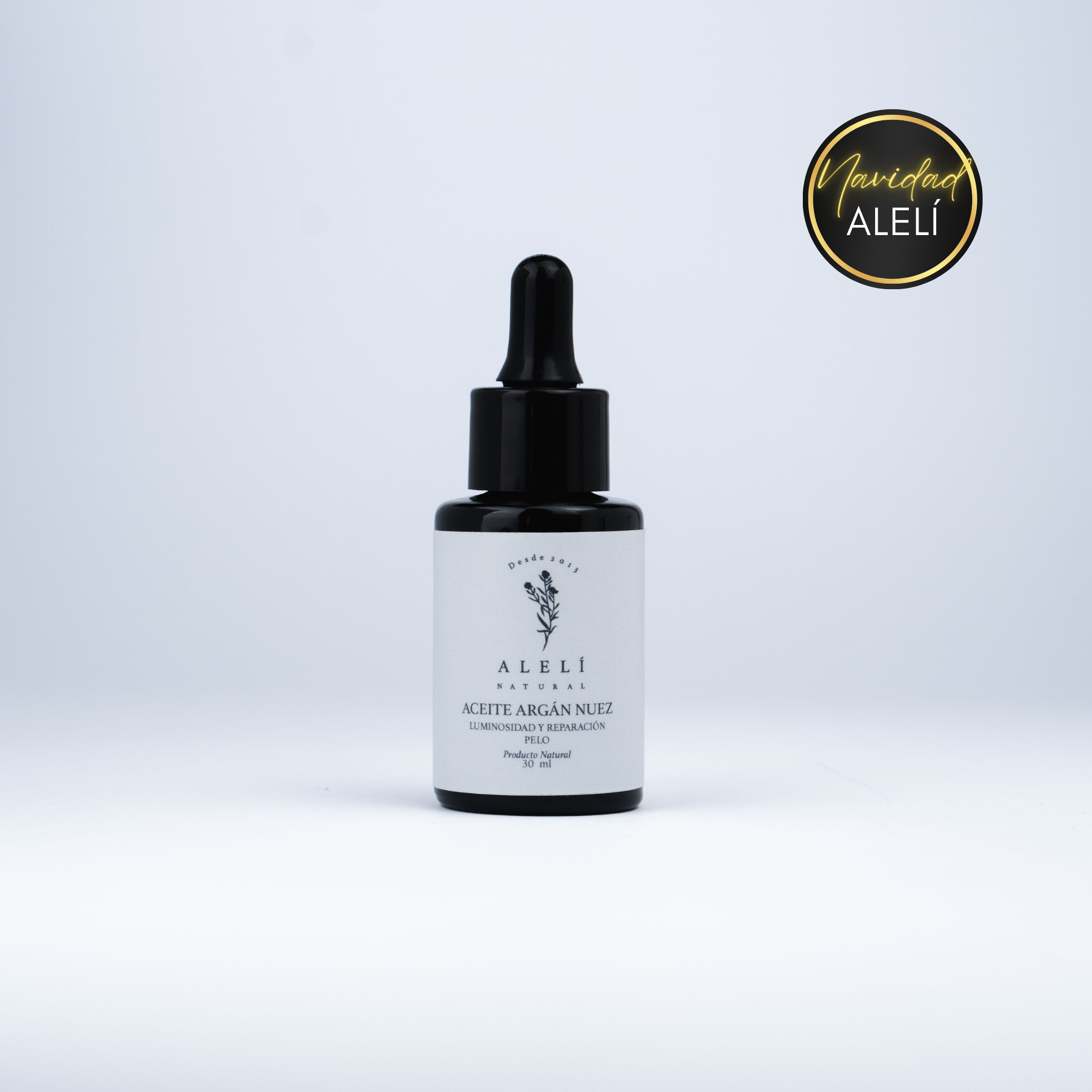 Vista frontal del Aceite Capilar Restaurador de Argán Nuez Alelí Natural de 30 ml con envase gotero ámbar. Navidad Alelí 35% Off.